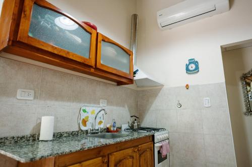 a kitchen with a sink and a counter top at Jumani Cabañas in San Rafael