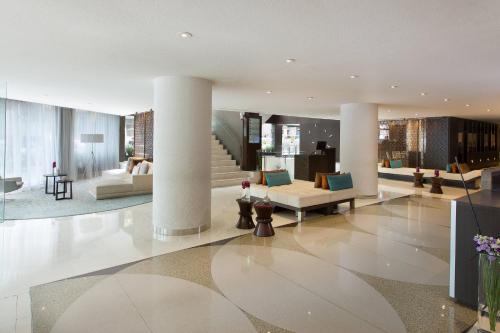 a lobby of a building with couches and chairs at Renaissance Barcelona Hotel in Barcelona