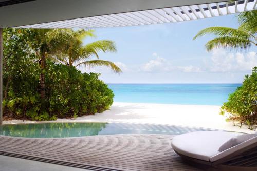 a view of the beach from a resort patio at The Ritz-Carlton Maldives, Fari Islands in North Male Atoll