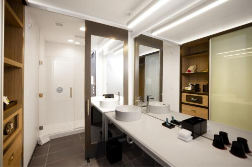 a bathroom with two sinks and a large mirror at Aloft Austin Airport in Austin