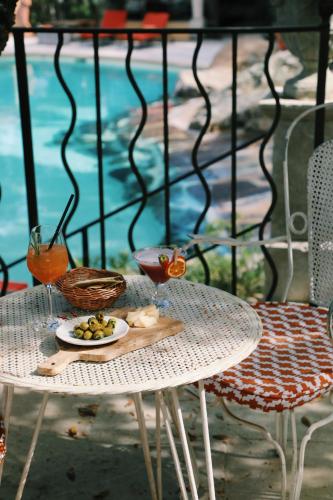 a table with a plate of food and a drink at Hôtel Villa Marie Saint Tropez in Saint-Tropez