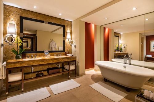 a bathroom with a tub and a large mirror at JW Marriott Hotel Bogotá in Bogotá