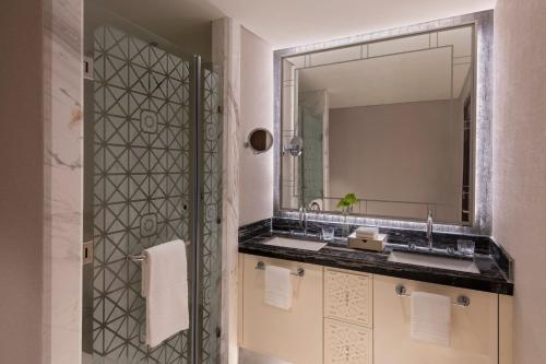 a bathroom with a sink and a mirror at The St. Regis Marsa Arabia Island, The Pearl Qatar in Doha