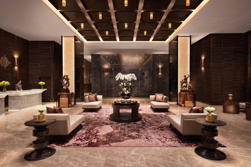 a lobby of a hotel with couches and a table at Bangkok Marriott Hotel The Surawongse in Bangkok