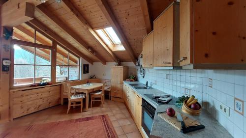 a kitchen with wooden cabinets and a table in it at Panoramaferienwohnung Resch in Bischofswiesen