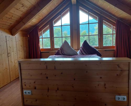 a bed in a room with a large window at Panoramaferienwohnung Resch in Bischofswiesen
