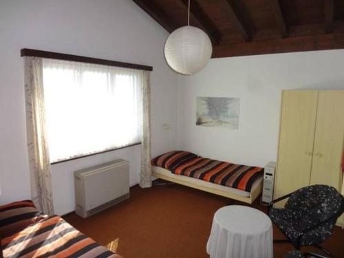 ein Wohnzimmer mit einem Bett und einem Fenster in der Unterkunft Casa Silvia - freistehendes Ferienhaus in Scareglia - Valcolla - Lugano in Cimadera