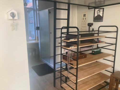 a room with a book shelf with books at La bellétage by Agelandkaai be with Free Parking in Ghent