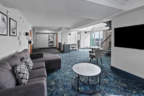 a living room with a couch and a table at Sheraton Fallsview Hotel in Niagara Falls