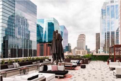 a rooftop patio with couches and tables and buildings at JW Marriott Austin in Austin