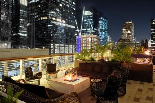 a rooftop patio with a fire pit and a city skyline at JW Marriott Austin in Austin