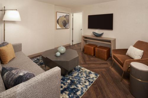 a living room with a couch and a tv at The Westin Indianapolis in Indianapolis