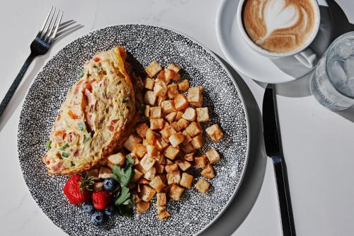 a plate of food with toast and fruit and a cup of coffee at The Westin Indianapolis in Indianapolis