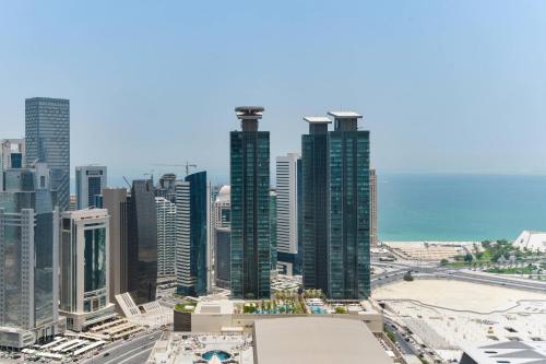 a view of a city skyline with skyscrapers at Marriott Marquis City Center Doha Hotel in Doha