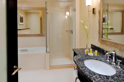 a bathroom with a sink and a shower at Marriott Marquis City Center Doha Hotel in Doha