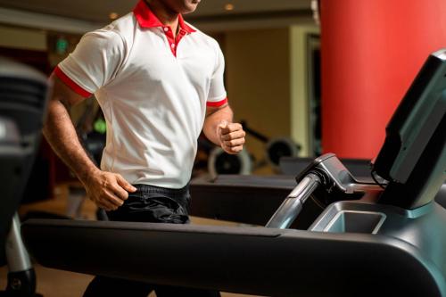 a man running on a treadmill in a gym at Marriott Marquis City Center Doha Hotel in Doha