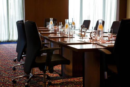 a long table in a room with chairs around it at Marriott Marquis City Center Doha Hotel in Doha