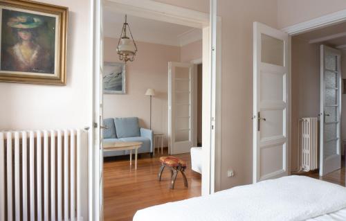 a bedroom with a bed and a living room at Hadrians Den in Heart of Plaka by JJ Hospitality in Athens