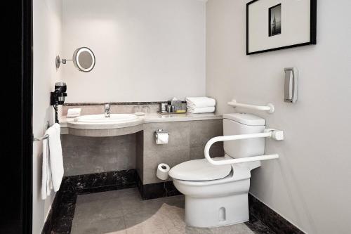 a bathroom with a toilet and a sink at Marriott Mena House, Cairo in Cairo