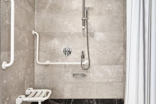 a bathroom with a shower with a bench in it at Marriott Mena House, Cairo in Cairo