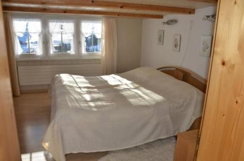 a bedroom with a bed and a window at Breiten in Brunnadern