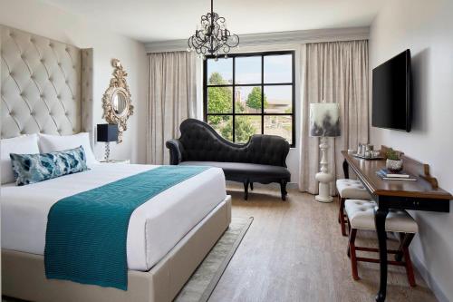 a bedroom with a bed and a desk and a chair at The Edwin Hotel, Autograph Collection in Chattanooga