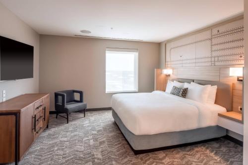 a hotel room with a bed and a television at SpringHill Suites by Marriott Fort Worth Historic Stockyards in Fort Worth