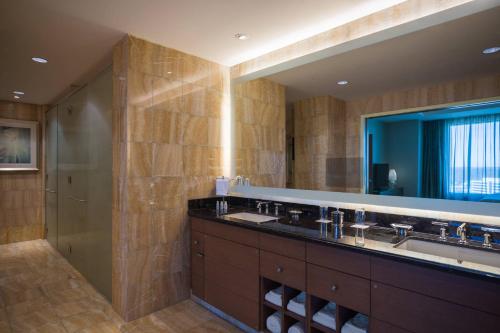 a bathroom with a double sink and a mirror at Renaissance Schaumburg Convention Center Hotel in Schaumburg