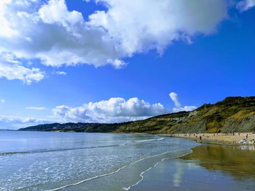 a view of a beach with people on the shore at Newlands Holidays in Bridport