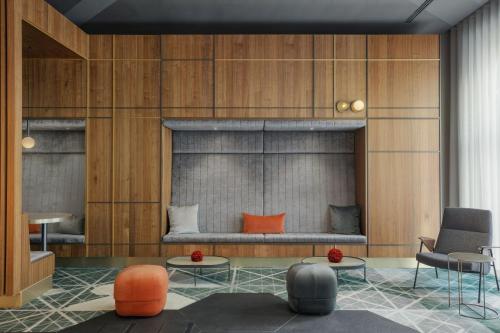 a room with a bed and two chairs and tables at Berlin Marriott Hotel in Berlin