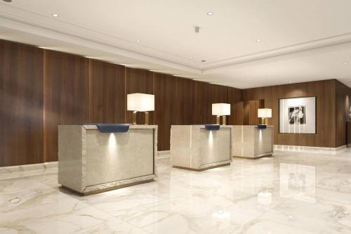 a lobby with three podiums in a building at Athens Marriott Hotel in Athens