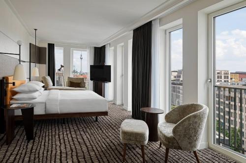 a hotel room with a bed and a balcony at Berlin Marriott Hotel in Berlin