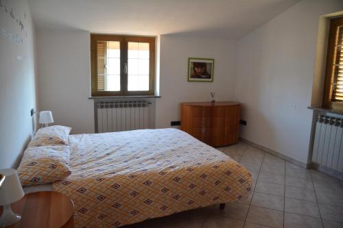 a bedroom with a bed and a table and window at A. F.antastic V.iew in Costa Volpino