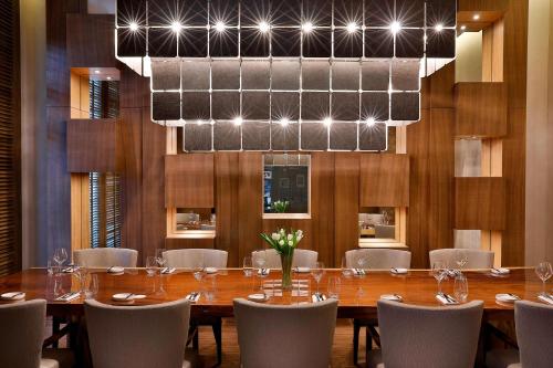 a dining room with a long table and chairs at Marriott Hotel Al Forsan, Abu Dhabi in Abu Dhabi
