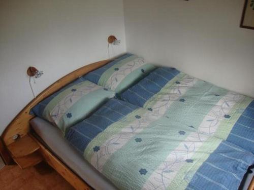 a bed in a corner of a bedroom at Alten-Hof in Bischofszell