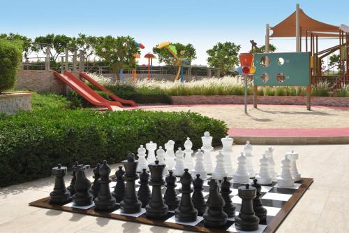 a chessboard in front of a playground with a slide at Marriott Hotel Al Forsan, Abu Dhabi in Abu Dhabi