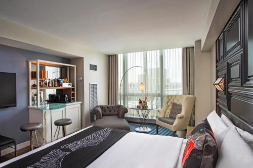 a hotel room with a bed and a desk and chairs at W Boston in Boston