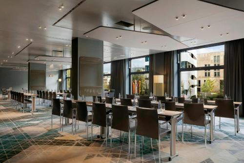 a conference room with tables and chairs in a building at Berlin Marriott Hotel in Berlin