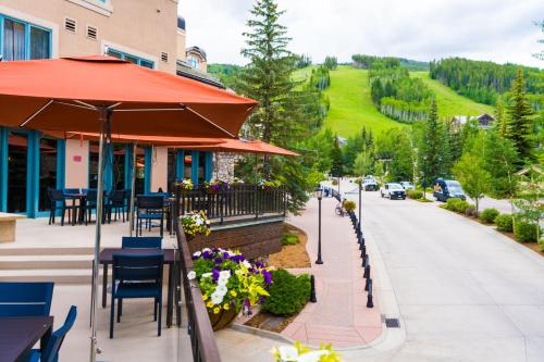 a restaurant with an umbrella and a street at Beaver Creek Lodge, Autograph Collection in Beaver Creek