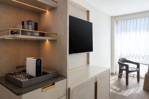 a living room with a tv on a wall at VEA Newport Beach, a Marriott Resort & Spa in Newport Beach