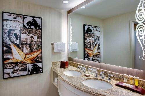 a bathroom with two sinks and a large mirror at Gaylord Texan Resort and Convention Center in Grapevine