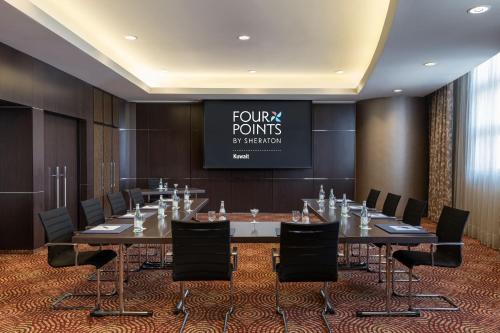 a conference room with a large table and chairs at Four Points By Sheraton Kuwait in Kuwait
