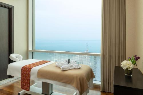 a hotel room with a bed and a large window at Four Points By Sheraton Kuwait in Kuwait