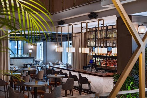 a restaurant with tables and chairs and a bar at Austin Marriott Downtown in Austin