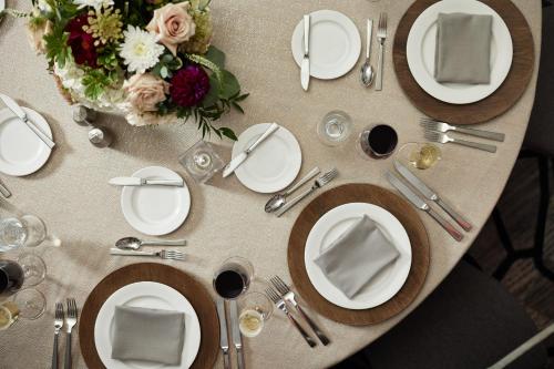 a table with white plates and flowers on it at JW Marriott Indianapolis in Indianapolis