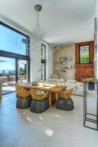 a living room with a wooden table and chairs at 5 Terrazze Exlusive Apartments in Gargnano