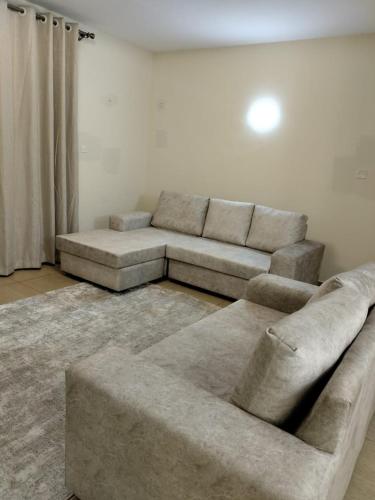 a living room with a couch and a table at Lux Suites Thika Gateway Apartments in Thika