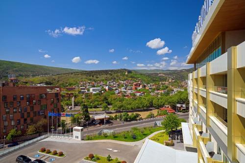 a view of a city from a building at Sheraton Grand Tbilisi Metechi Palace in Tbilisi City