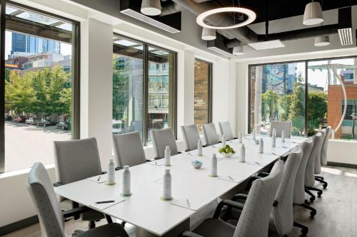 a large conference room with a long table and chairs at Astra Hotel, Seattle, a Tribute Portfolio Hotel in Seattle
