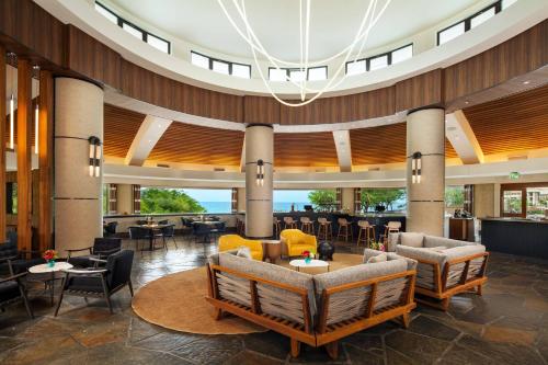 a lobby of a hotel with chairs and tables at The Westin Hapuna Beach Resort in Hapuna Beach